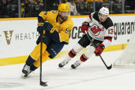 Nashville Predators defenseman Roman Josi (59) moves the puck ahead of New Jersey Devils center Nico Hischier (13) in the first period of an NHL hockey game Friday, Nov. 26, 2021, in Nashville, Tenn. (AP Photo/Mark Humphrey)