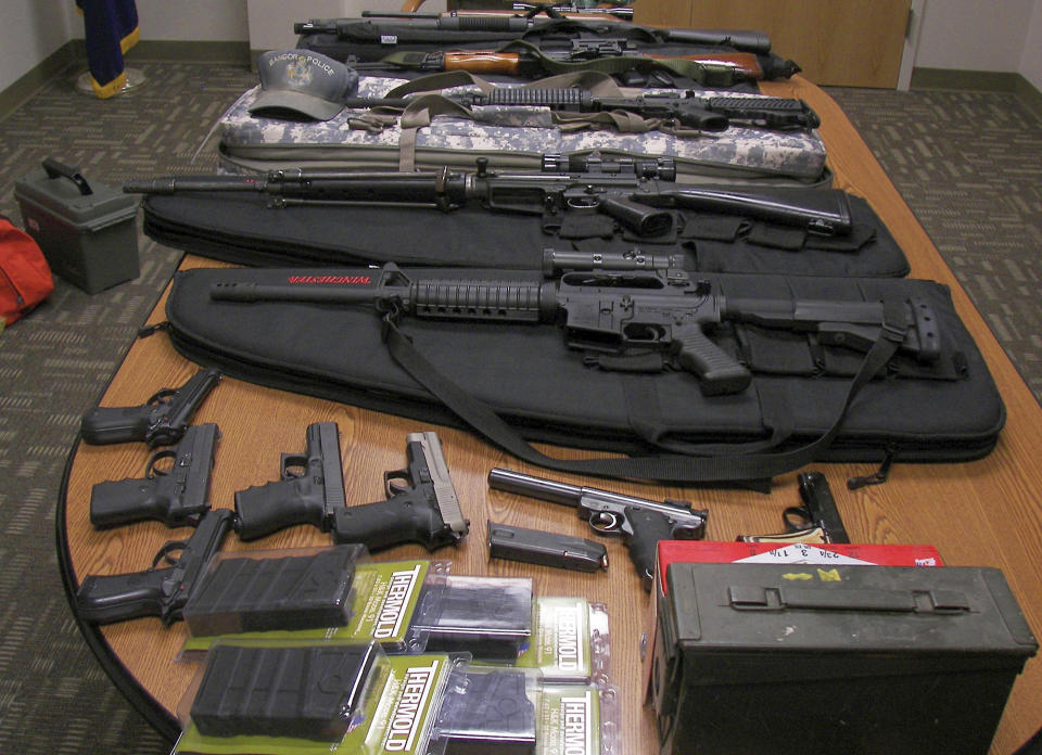 This undated photograph released by the Maine State Police shows weapons gathered from the home and vehicle of Timothy Courtois, of Biddeford, Maine, who was arrested Sunday, July 22, 2012 on charges of having a concealed weapon and speeding on the Maine Turnpike. Found in his car were an assault weapon, four handguns and several boxes of ammunition. A search of his home revealed several additional weapons, including a machine gun, and thousands of rounds of ammunition. Courtois told authorities he was on his way to Derry, N.H., to shoot a former employer. He also said he had attended the Batman movie the previous night. (AP Photo/Maine State Police)