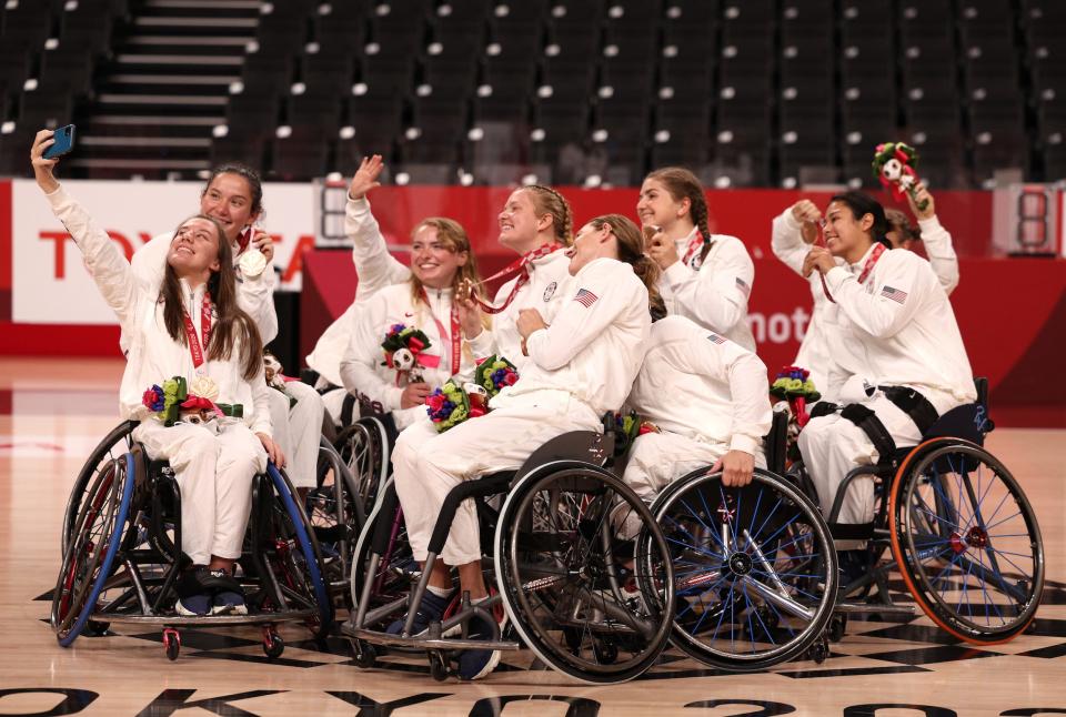 American Wheelchair Basketball players pose with their bronze medals from the Tokyo Paralympics.