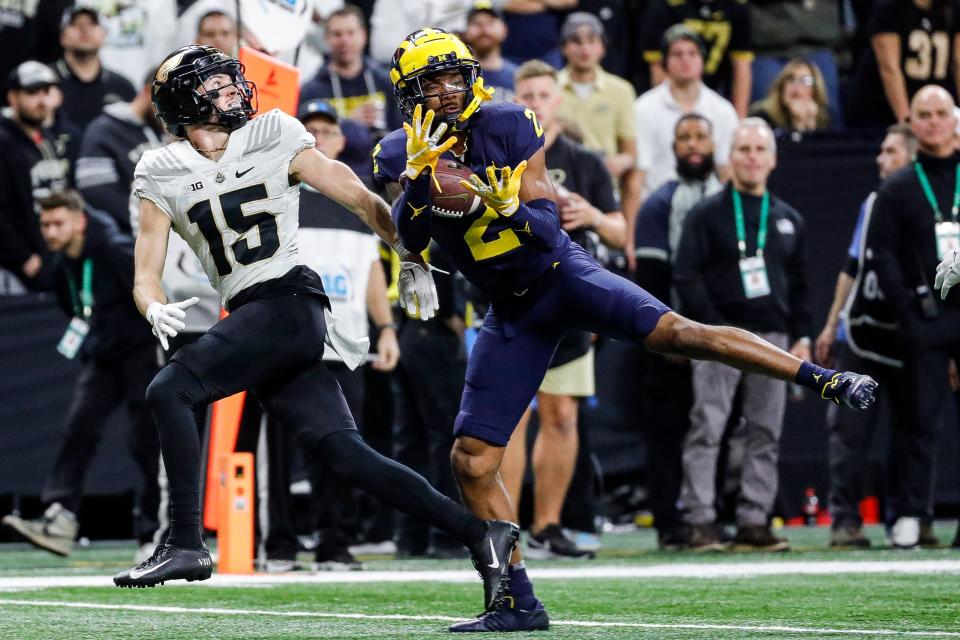 Michigan defensive back Will Johnson (2) intercepts a pass intended for Purdue wide receiver Charlie Jones (15) during the second half of the Big Ten Championship game at Lucas Oil Stadium in Indianapolis, Ind., on Saturday, Dec. 3, 2022.