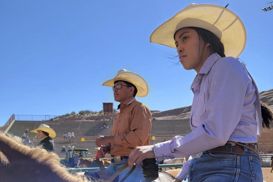 In this undated photo provided by Tyrone Tsosie, his children Tydon and Tyra Tsosie, compete in a rodeo event in Gallup, N.M. Born out of necessity and in mastering skills that came as horses transformed hunting, travel and warfare, rodeo has remained popular in Native American communities. Grandstands often play host to mini family reunions while Native cowboys and cowgirls show off their skills roping, riding and wrestling livestock. (Tyrone Tsosie via AP)