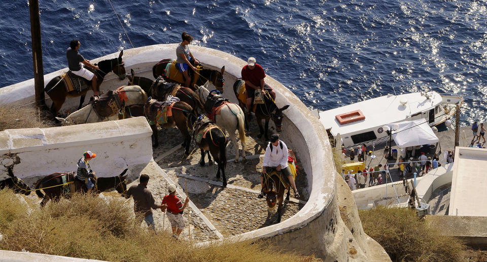 Up to 1,200 tourists visit the small island every day between May and October to take in its beautiful scenery, and many hire donkeys to carry them up to the best viewpoints. Source: Getty