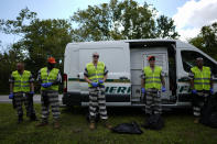 Members of Brevard County's chain gang, prisoners convicted of non-violent misdemeanors, wear chains around their ankles as they take a water break from picking up trash along a roadside, Thursday, Sept. 14, 2023, in Titusville, Fla. Participation in the chain gang, created by county Sheriff Wayne Ivey as a crime deterrent, is voluntary and sometimes has a waitlist to join. (AP Photo/Rebecca Blackwell)