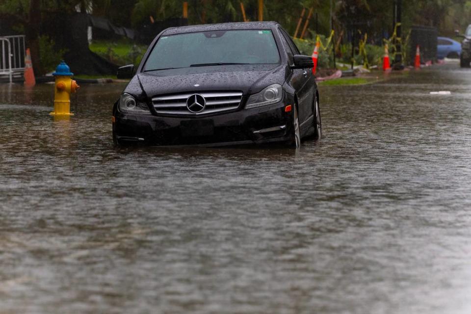 A vehicle is parked by the flooded road due to heavy rain at North Bay Rd and 180th Dr. in Sunny Isles Beach on Tuesday, June 11, 2024 in Florida.