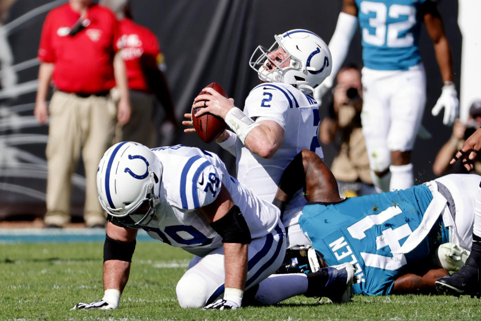 Indianapolis Colts quarterback Carson Wentz (2) is sacked by Jacksonville Jaguars outside linebacker Josh Allen (41) during the first half of an NFL football game, Sunday, Jan. 9, 2022, in Jacksonville, Fla. (AP Photo/Stephen B. Morton)