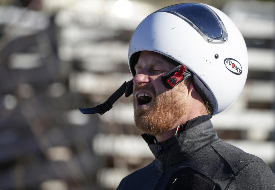 Prince Harry, the Duke of Sussex, reacts after sliding down the track on a skeleton sled during an Invictus Games training camp, in Whistler, British Columbia, Thursday, Feb. 15, 2024. Invictus Games Vancouver Whistler 2025 is scheduled to take place from Feb. 8 to 16, 2025 and will for the first time feature winter sports. (Darryl Dyck/The Canadian Press via AP)