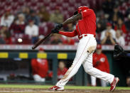 Cincinnati Reds' Aristides Aquino hits a RBI single to win the game against Washington Nationals pitcher Mason Thompson during the 11th inning of a baseball game in Cincinnati, Friday, Sept. 24, 2021. The Reds won 8-7. (AP Photo/Paul Vernon)