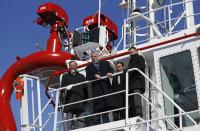 Liberal leader Philippe Couillard (2nd L) speaks while he tours a tug boat during a campaign stop at Groupe Ocean Industries in Quebec City, March 7, 2014. Quebec voters will head to the poll for a provincial election on April 7. REUTERS/Mathieu Belanger (CANADA - Tags: POLITICS ELECTIONS)