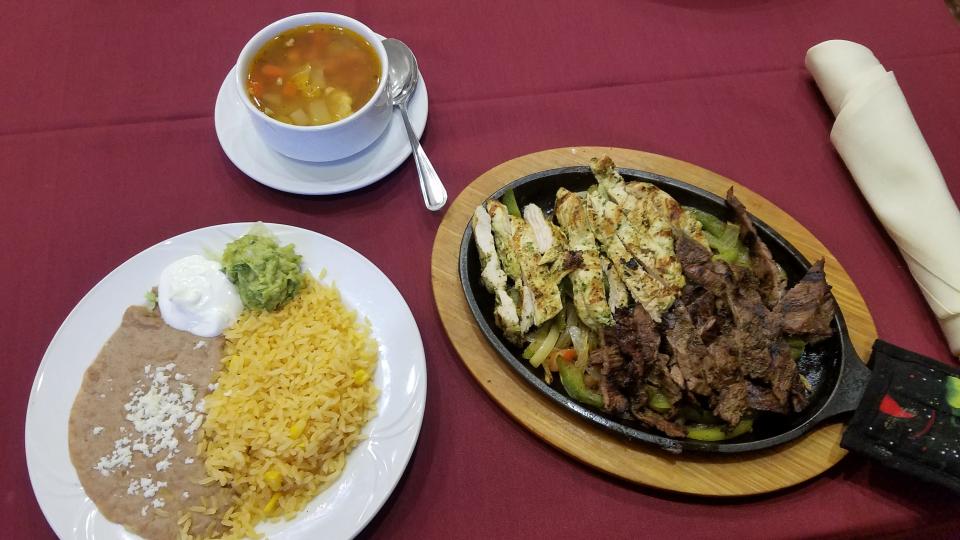 Chicken and steak fajitas with Mexican rice and beans with soup.