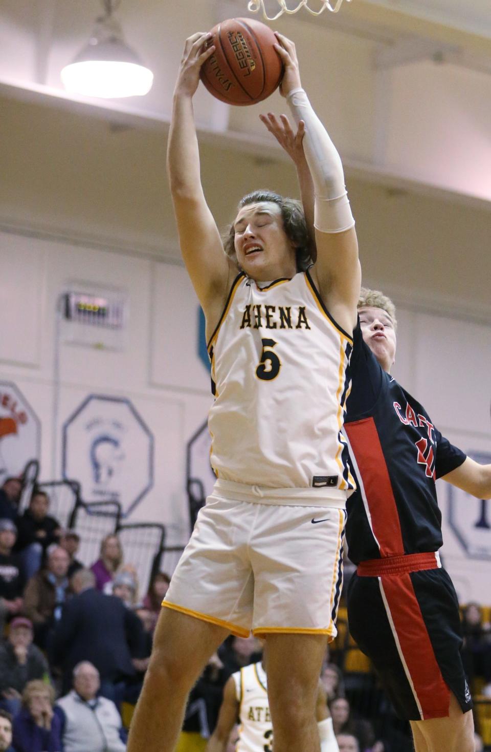 Athena's Connor Osier pulls down a defensive rebound over Hilton's Ben Sneddon.