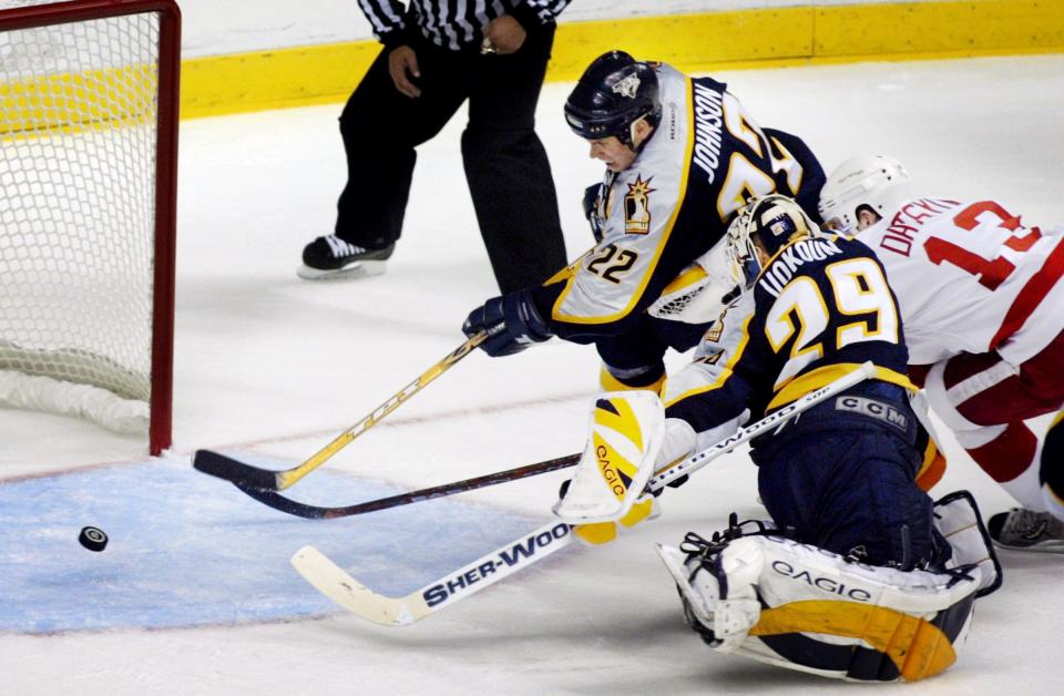 Nashville Predators’ Greg Johnson (22) helps goalie Tomas Vokoun to clear the puck in front of the goal as Detroit Red Wings’ Pavel Datsyuk (13) tries to score during the 2004 playoffs.