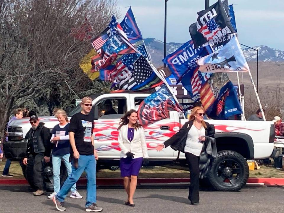 Idaho Lt. Gov. Janice McGeachin, center, and state GOP vice chair Machele Hamilton, right, attend a rally in Boise with hundreds of others in support of a group of long-haul semi-truckers who drove to Washington, D.C., to protest COVID-19 mandates, on March 2, 2022.