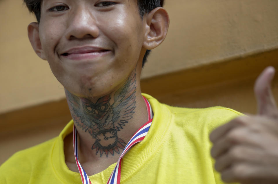 A supporter of the monarchy gives a thumb-up during a gathering outside German Embassy in central Bangkok, Thailand Monday, Oct. 26, 2020. The royalists gathered to defend pro-democracy protesters' contention that King Maha Vajiralongkorn spends much of his time in Germany conducting Thai political activities. German government officials have recently expressed concern over political activities the king might be conducting on the Germany's soil. (AP Photo/Gemunu Amarasinghe)