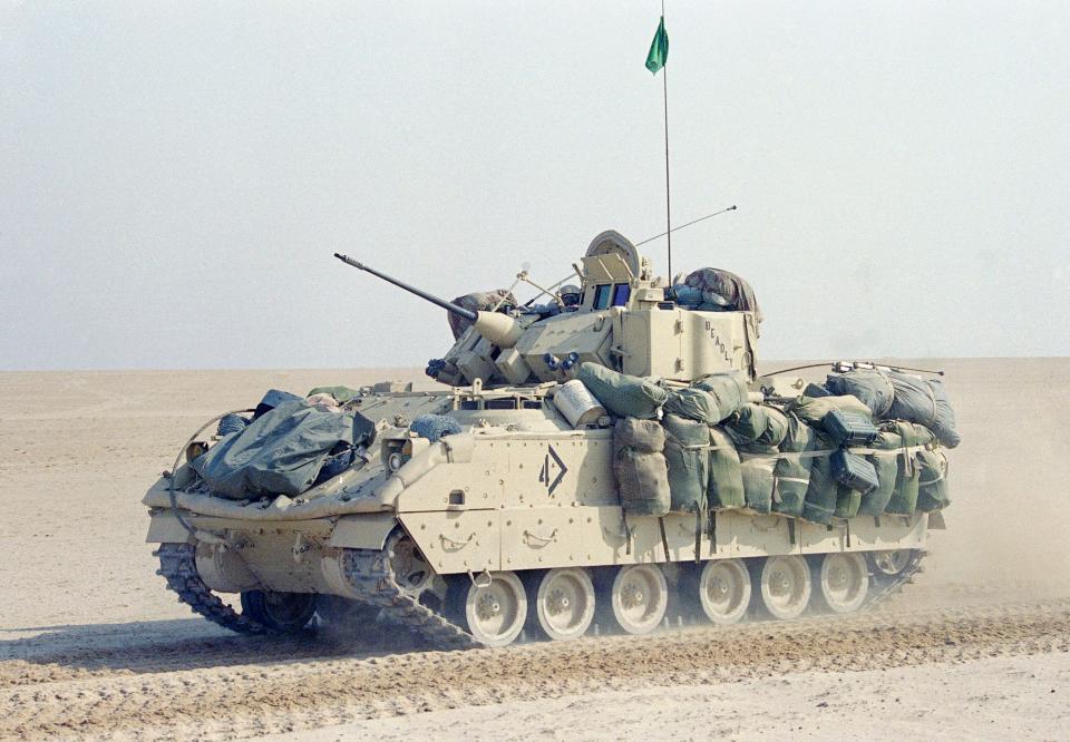 A Bradley fighting vehicle from the  USArmy 2nd Armored division drives through Saudi Arabian desert on Jan. 18, 1991.