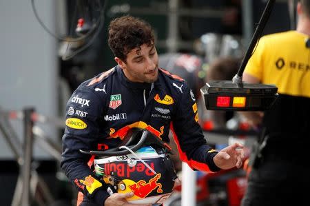 Formula One - F1 - Australian Grand Prix - Melbourne, Australia - 25/03/2017 Red Bull Racing driver Daniel Ricciardo of Australia reacts as he walks down pit lane after crashing out of the qualifying session. REUTERS/Brandon Malone