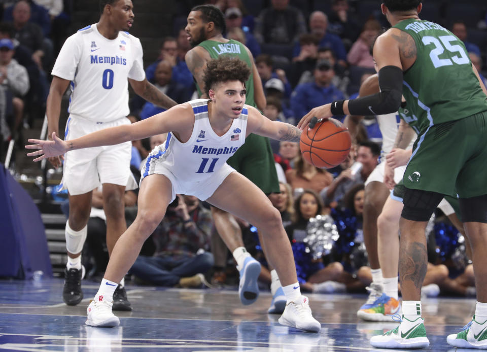 Memphis' guard Lester Quinones (11) defends Tulane guard Christion Thompson (25) in the second half of an NCAA college basketball game Monday, Dec. 30, 2019, in Memphis, Tenn. (AP Photo/Karen Pulfer Focht)