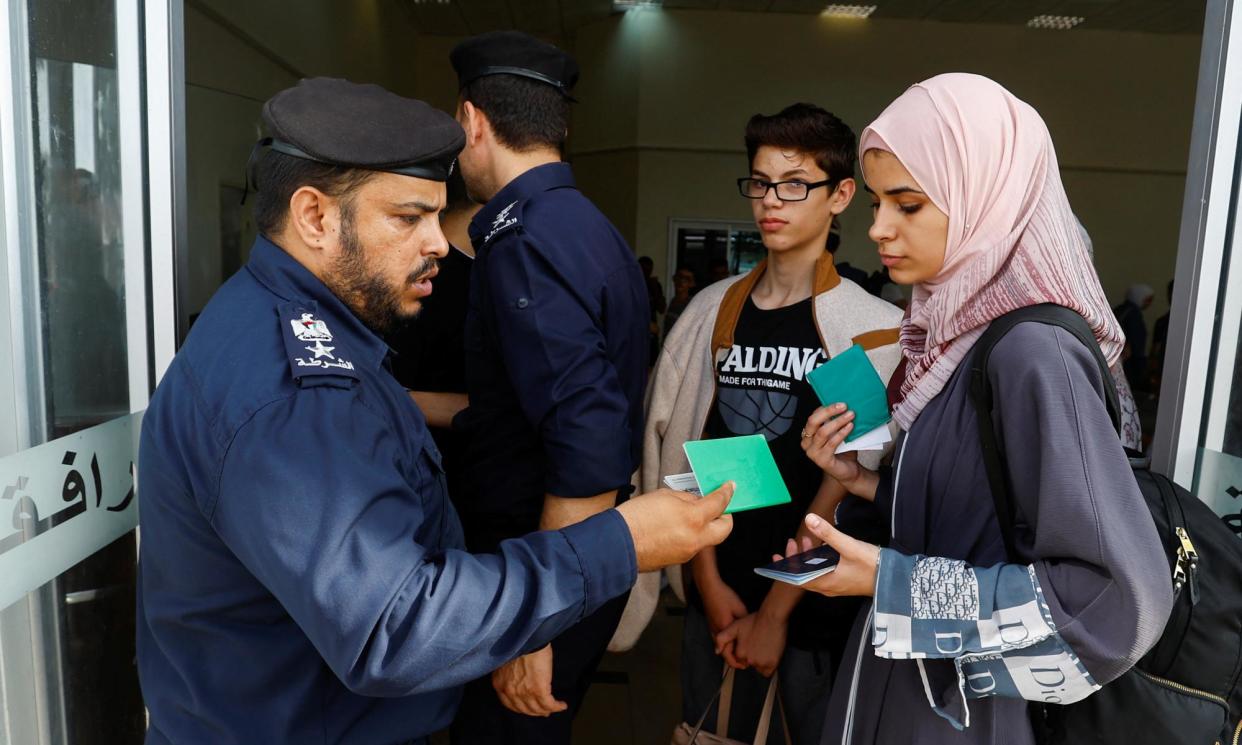 <span>Palestinians holding foreign passports wait for permission to leave Gaza at the Rafah border crossing with Egypt, November 2023.</span><span>Photograph: Ibraheem Abu Mustafa/Reuters</span>