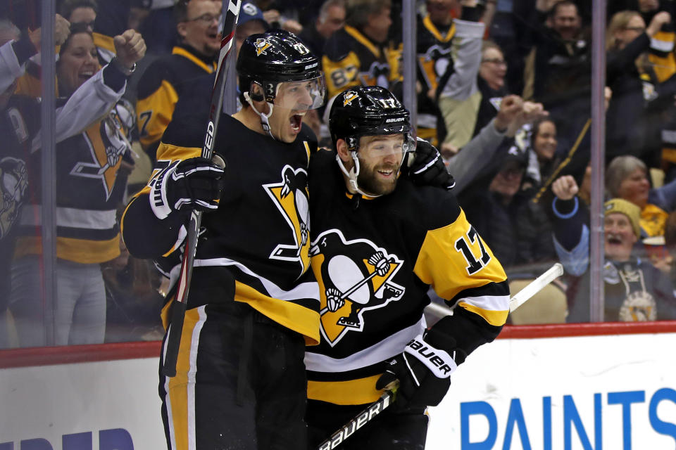 Pittsburgh Penguins' Bryan Rust (17) celebrates his goal with Evgeni Malkin (71), who had an assist, during the second period of the team's NHL hockey game against the Minnesota Wild in Pittsburgh, Tuesday, Jan. 14, 2020. (AP Photo/Gene J. Puskar)