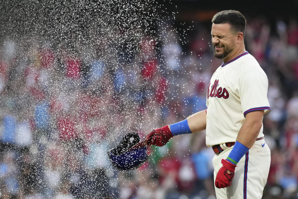 Philadelphia Phillies' Kyle Schwarber is doused by Alec Bohm after hitting a game-winning RBI-sacrifice fly against San Diego Padres relief pitcher Tim Hill during the 12th inning of a baseball game, Sunday, July 16, 2023, in Philadelphia. (AP Photo/Matt Slocum)