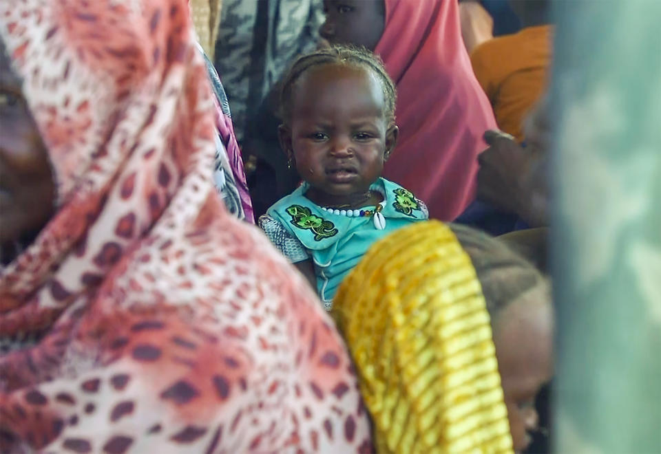 FILE - Sudanese refugees gather outside a field hospital in Acre, Chad, Aug. 15, 2023. The United Nations food agency has warned that it might end food assistance to 1.4 million refugees in Chad who fled the conflict in parts of the Sahel because of limited funding. The World Food Program says most of the refugees escaped the war in Sudan and crossed into Chad in the last six months in numbers not seen in the last 20 years. (AP Photo, File )