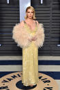 <p>Roberts channeled Old Hollywood glamour in a yellow beaded gown with a feathered stole. (Photo: John Shearer/Getty Images) </p>