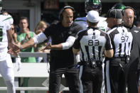 New York Jets head coach Robert Saleh, left, argues with referees during the first half of an NFL football game against the New England Patriots, Sunday, Sept. 19, 2021, in East Rutherford, N.J. (AP Photo/Bill Kostroun)