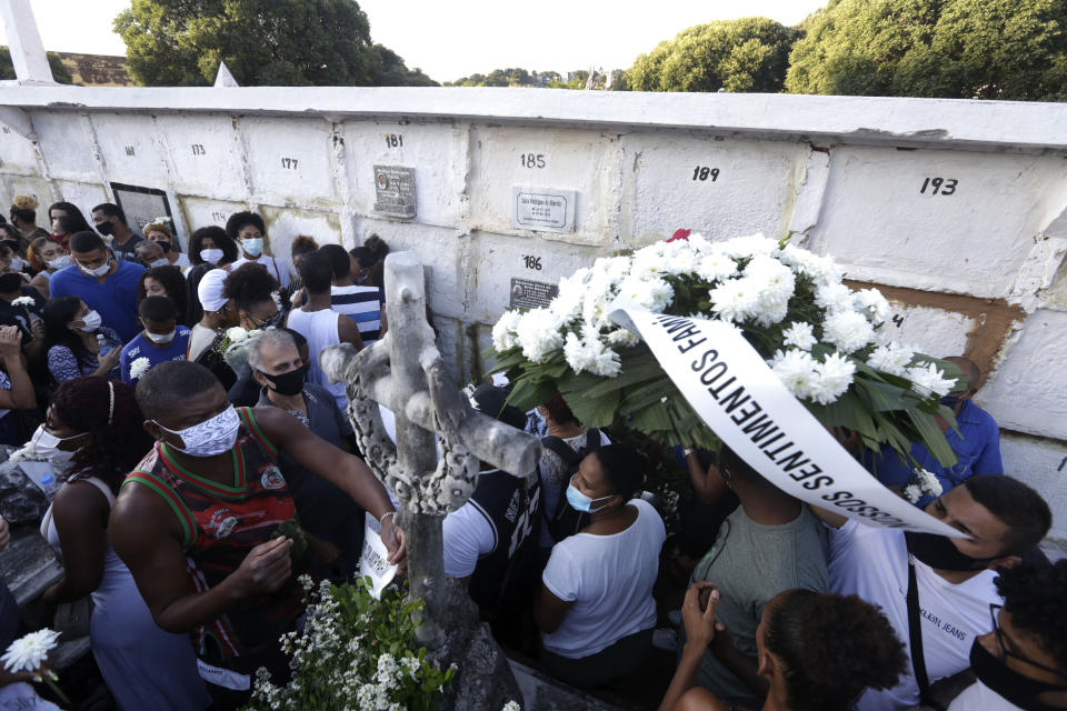 Family and friends attend the funeral of Kathlen Romeu, a young pregnant woman killed by a stray bullet, in Rio de Janeiro, Brazil, Wednesday, June 9, 2021. Stray bullets have struck at least six pregnant women in Rio since 2017, but Romeu was the first to die, according to Crossfire, a non-governmental data project that tracks armed violence. (AP Photo/Bruna Prado)