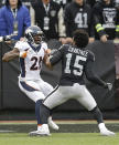 <p>Denver Broncos cornerback Aqib Talib (21) fights Oakland Raiders wide receiver Michael Crabtree (15) during the first half of an NFL football game in Oakland, Calif., Sunday, Nov. 26, 2017. (AP Photo/Ben Margot) </p>