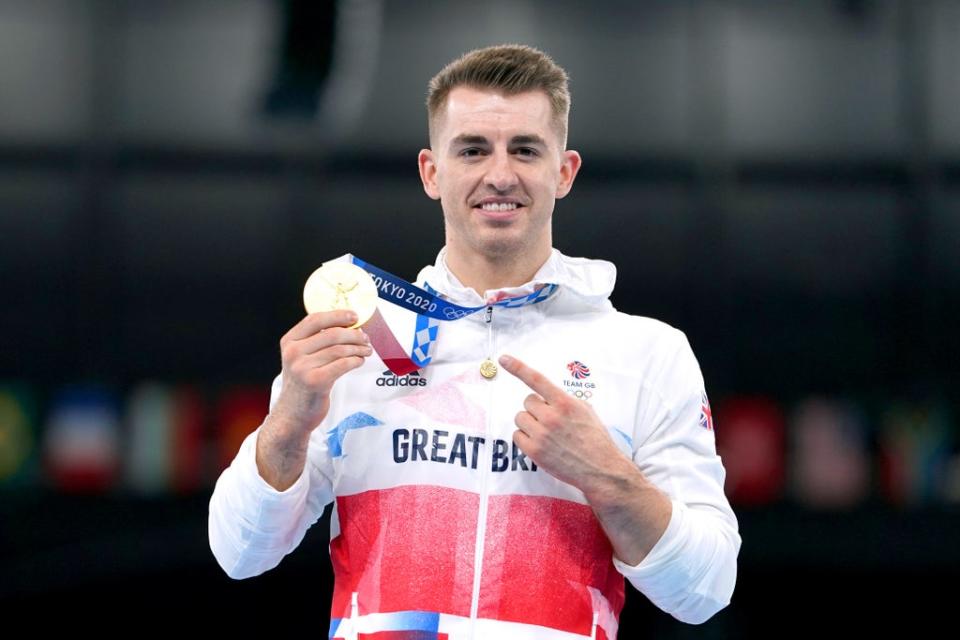 Max Whitlock celebrates with his gold medal after winning the men’s pommel horse final in Tokyo (Mike Egerton/PA)