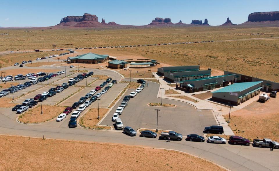 <span class="caption">Residents of the Navajo Nation in Monument Valley, Arizona, line up to collect water and supplies as COVID-19 spreads through the area. Approximately one-third of this sovereign territory’s 178,000 residents don’t have access to running water or sanitation.</span> <span class="attribution"><a class="link " href="https://www.gettyimages.com/detail/news-photo/navajo-indians-line-up-in-their-vehicles-to-collect-water-news-photo/1215970681?adppopup=true" rel="nofollow noopener" target="_blank" data-ylk="slk:Getty Images / Mark Ralston;elm:context_link;itc:0;sec:content-canvas">Getty Images / Mark Ralston</a></span>