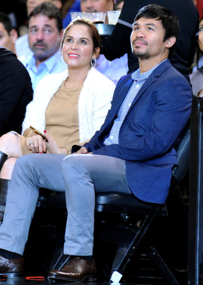 Boxer Manny Pacquiao (R) watches an NBA game with his wife, Jinkee. (Steve Mitchell-USA TODAY Sports)
