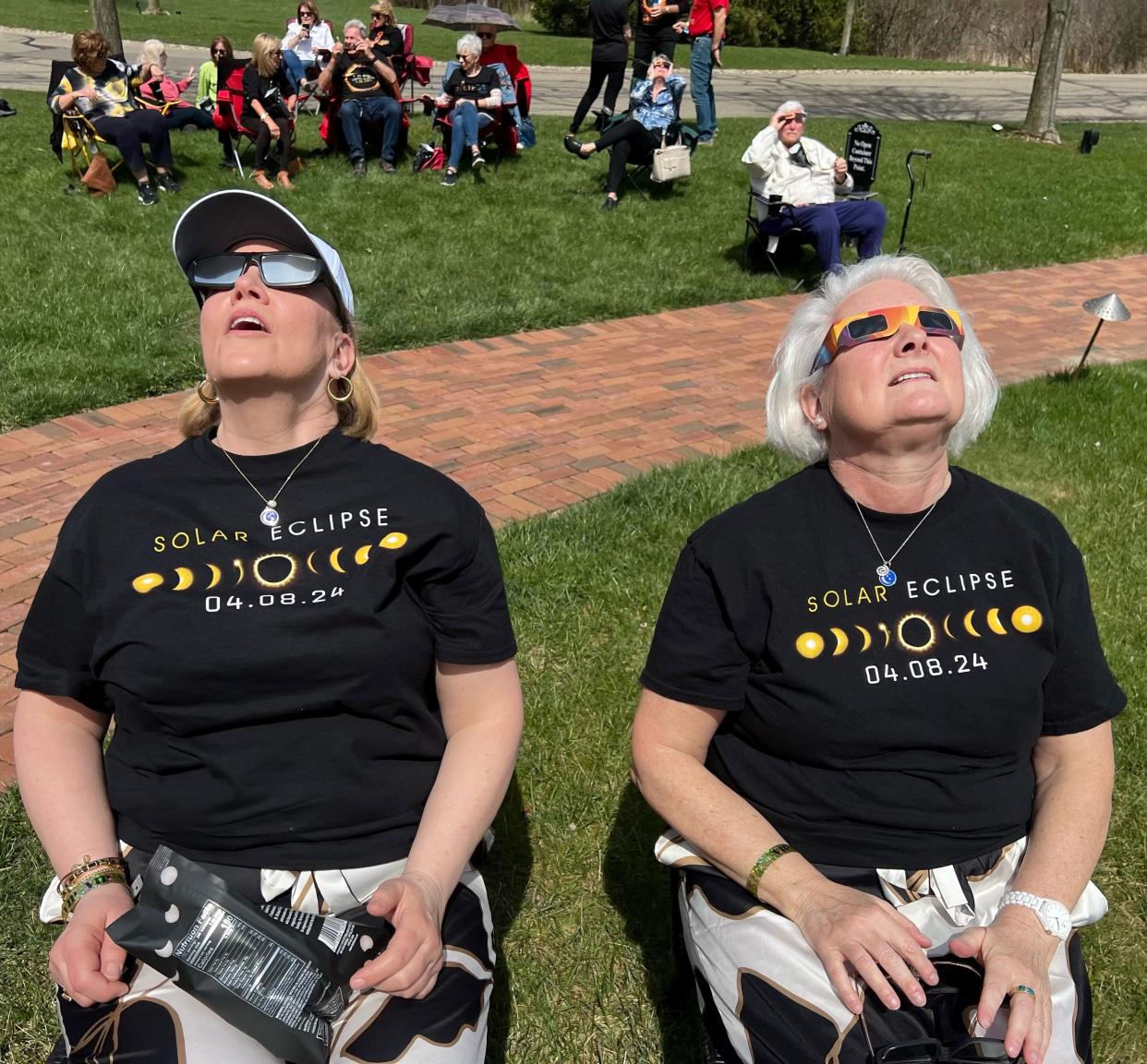 Joan Smith, right, of St. Paul, Minnesota, and Tama Ann of Columbus looks to the sky while awaiting the solar eclipse Monday at Gervasi Vineyard Resort & Spa.