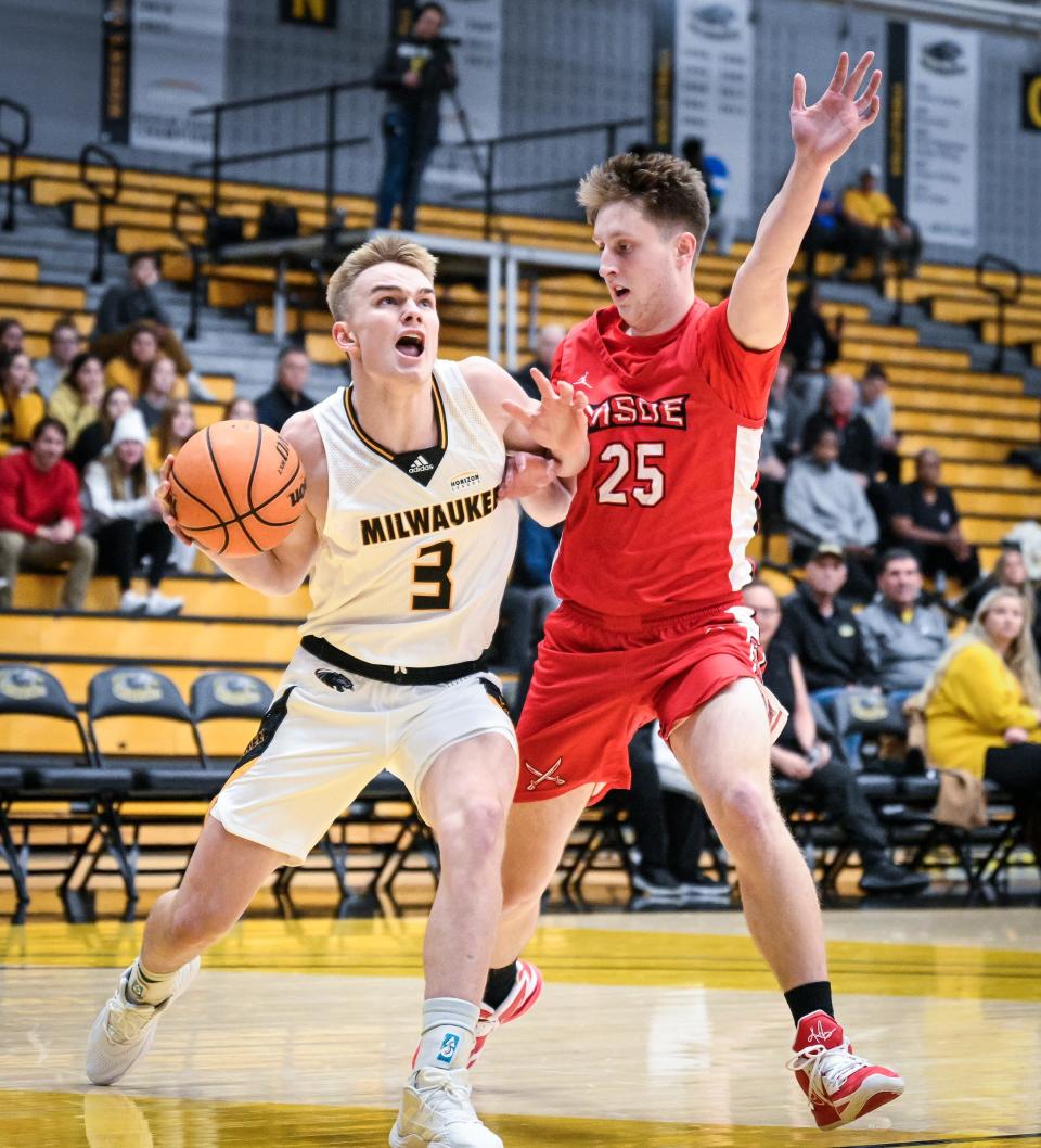UW-Milwaukee guard Zach Howell (3) drives to the basket against MSOE guard Chase Cummings (25)  in a college basketball season opener Monday, November 7, 2022, at the Klotsche Center in Milwaukee, Wisconsin.