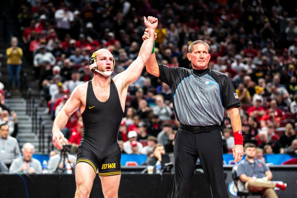 Iowa's Alex Marinelli has his hand raised after scoring a decision at 165 pounds in the finals on Sunday at Pinnacle Bank Arena in Lincoln, Nebraska.