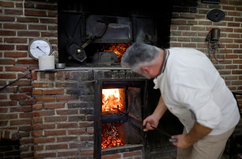 Baking bread over a wood fire in Challans