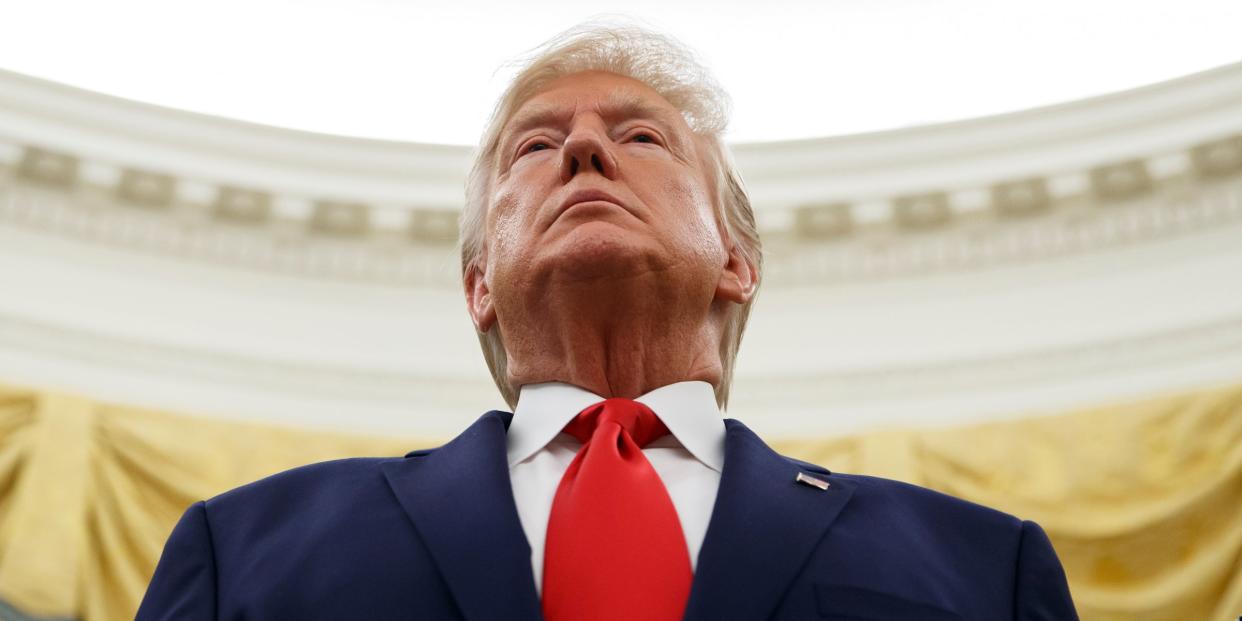 President Donald Trump stands during a Presidential Medal of Freedom ceremony for auto racing great Roger Penske in the Oval Office of the White House, Thursday, Oct. 24, 2019, in Washington. (AP Photo/Alex Brandon)