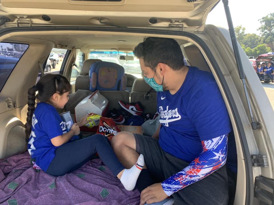 Erik Garcia brought little sister Melissa to the Dodgers' drive-in watch party of Game 2 of the NLCS.