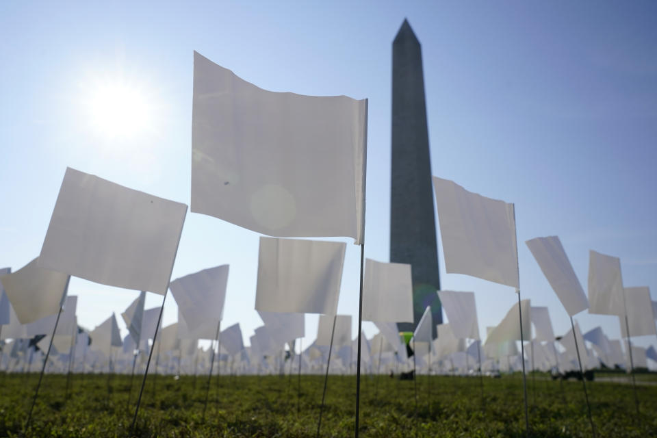 White flags stand near the Washington Monument on the National Mall in Washington, Wednesday, Sept. 15, 2021. The flags, which will number more than 630,000 when completed, are part of artist Suzanne Brennan Firstenberg's temporary art installation, "In America: Remember," in remembrance of Americans who have died of COVID-19. (AP Photo/Patrick Semansky)