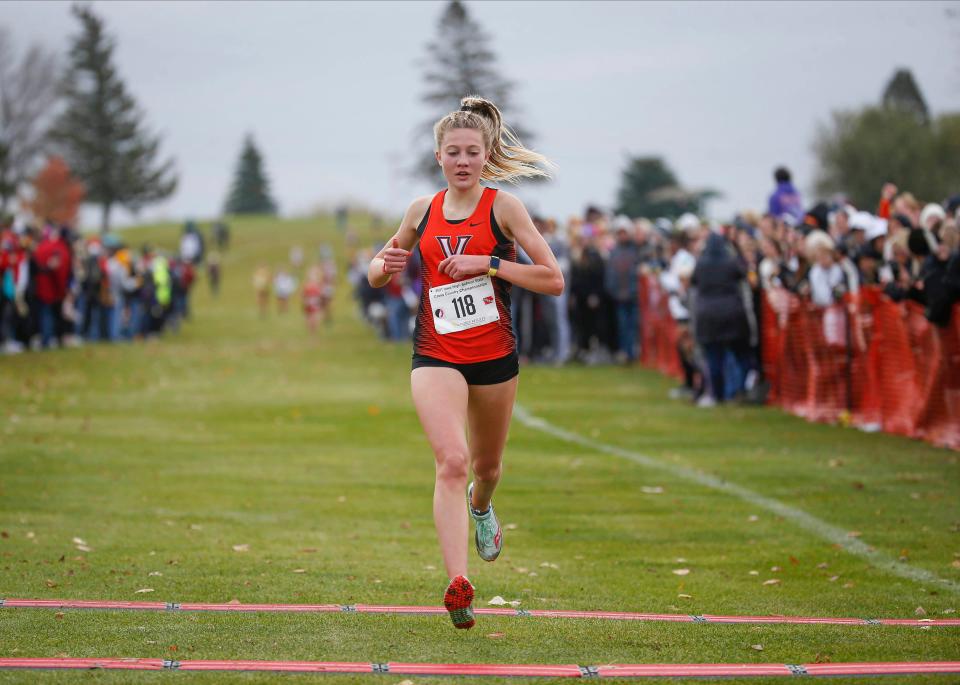 West Des Moines Valley sophomore Addison Dorenkamp crosses the finish line to win an individual title during the Class 4A Iowa high schools state cross country meet.