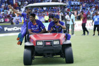 India's Dinesh Karthik, left, Ravichandran Ashwin, center, and Rohit Sharma ride in a cart after the fifth and final T20 cricket match against the West Indies, Sunday, Aug. 7, 2022, in Lauderhill, Fla. India won the match and the series. (AP Photo/Lynne Sladky)