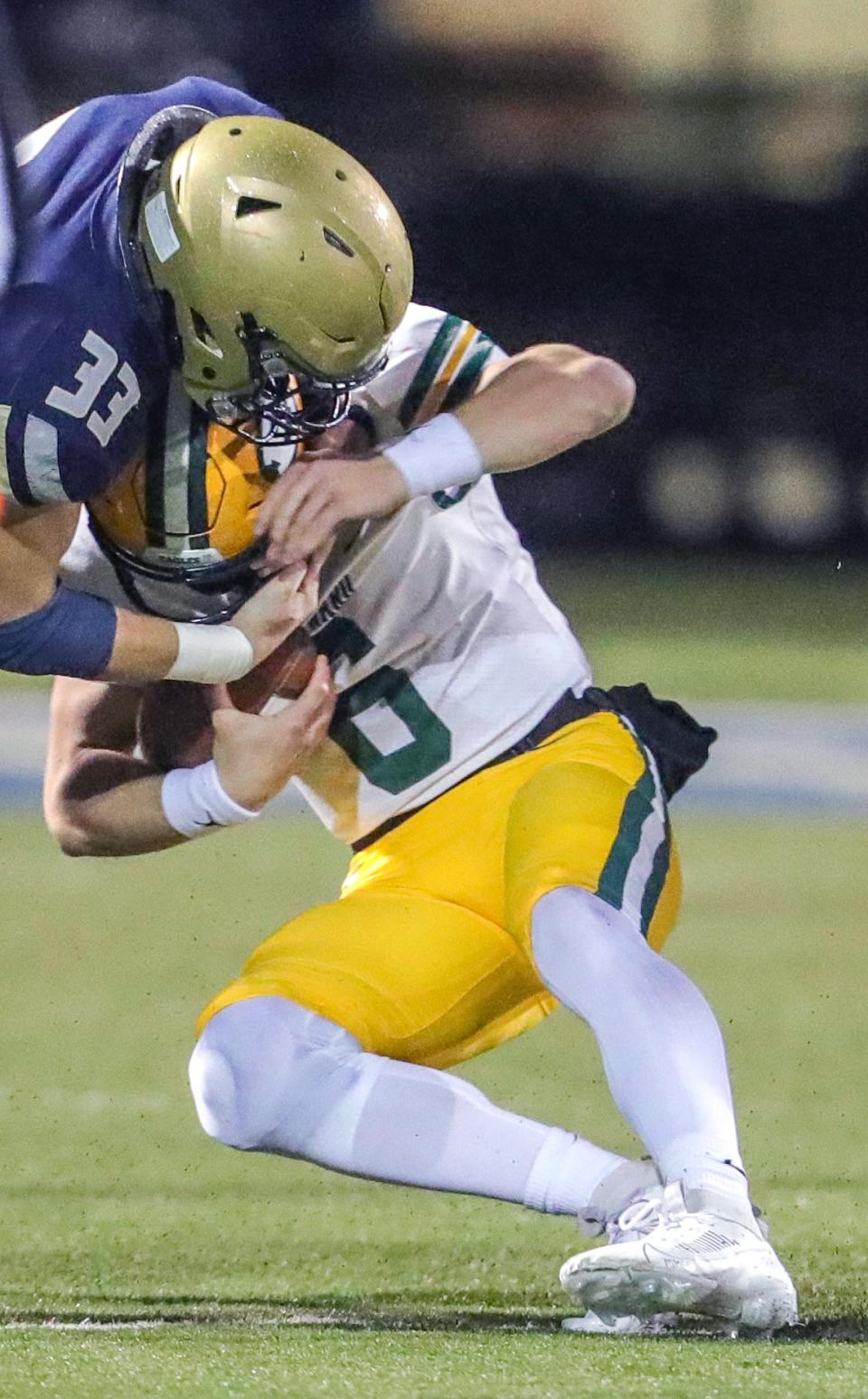 St. Edward quarterback Casey Bullock is taken down by Hoban linebacker Eli Lee on Friday in Akron.