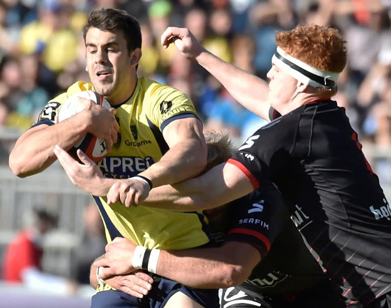 Clermont's Patricio Fernandez Fiante (L) vies with Lyon's Felix Lambey (R) during their French Top 14 rugby union match at the Matmut Stadium de Gerland in Lyon, central-eastern France