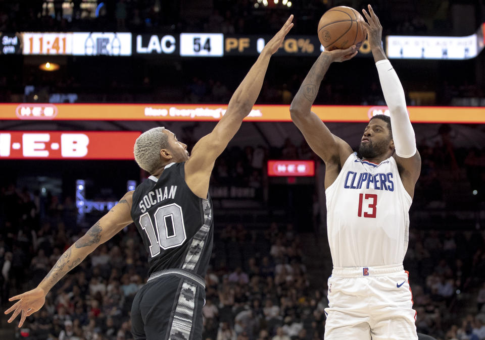 Los Angeles Clippers guard Paul George (13) shoots over San Antonio Spurs forward Jeremy Sochan (10) during the second half of an NBA basketball game Friday, Nov. 4, 2022, in San Antonio. (AP Photo/Nick Wagner)