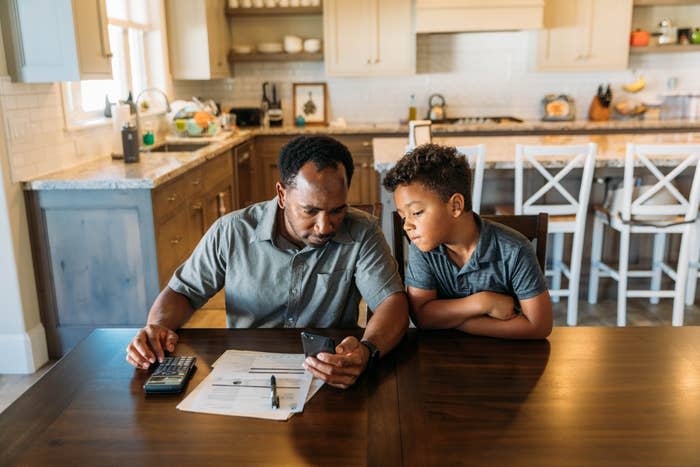 father and son looking at paperwork on the counter