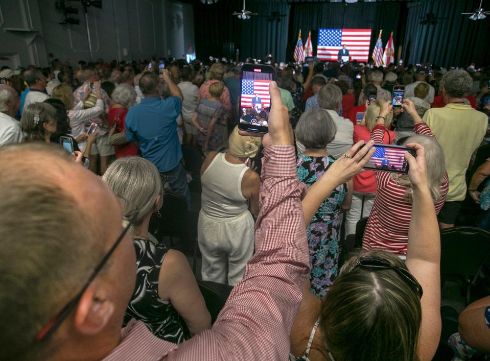 Florida Gov. Ron DeSantis supporters take video as he speaks to a crowd of 500 to 1,000 attendees at the Sahib Shriner Event Center on Sunday as part of his Education Agenda Tour across the state. MATT HOUSTON/HERALD-TRIBUNE