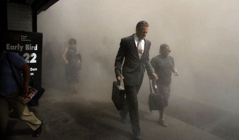 <p>Pedestrians flee the area of New York's World Trade Center in lower Manhattan on Tuesday, Sept. 11, 2001. (AP Photo/Amy Sancetta)</p> 