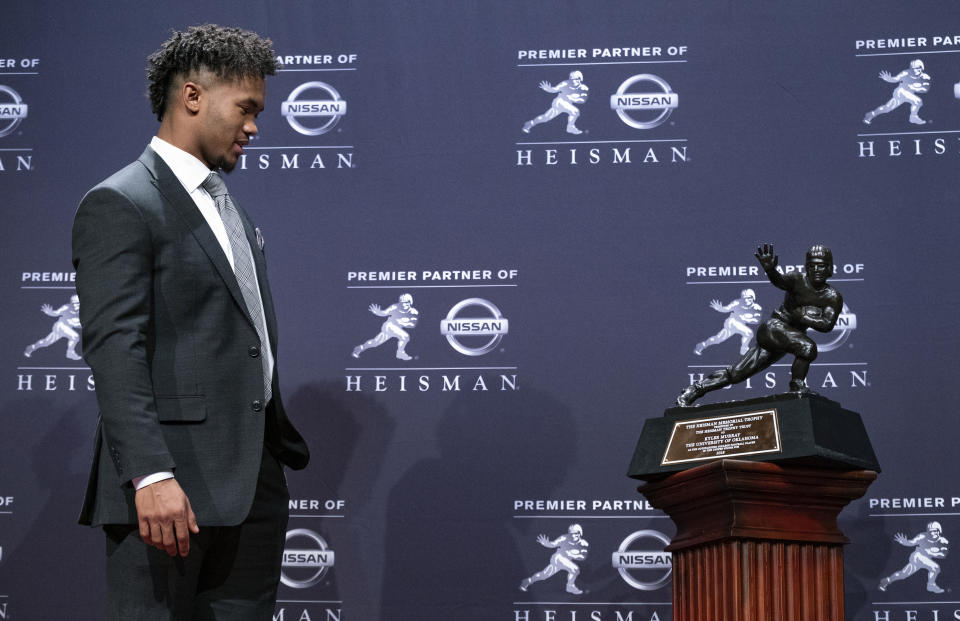 Oklahoma quarterback Kyler Murray, winner of the Heisman Trophy, looks at the award Saturday, Dec. 8, 2018, in New York. (AP Photo/Craig Ruttle)