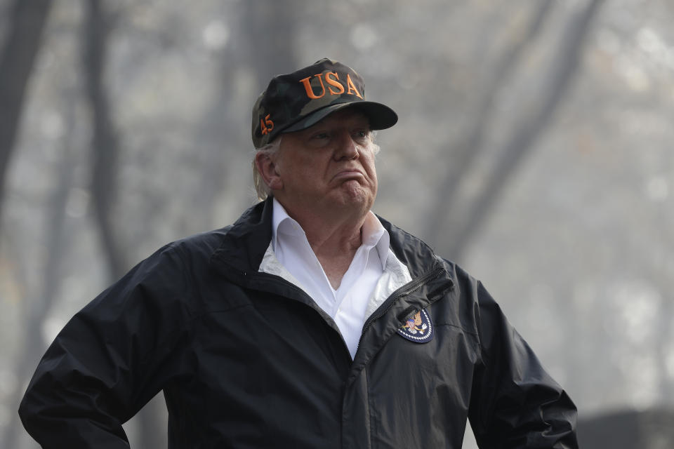 President Trump visits a neighborhood devastated by wildfires in Paradise, Calif., in November. (Photo: Evan Vucci/AP)