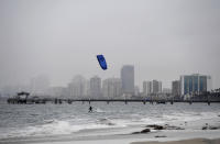 A wind surfer surfs in the rain in Long Beach, Calif., on Monday, Oct. 25, 2021. (Brittany Murray/The Orange County Register via AP)