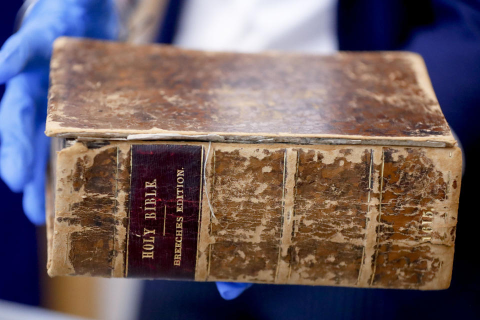 FBI supervisory special agent Shawn Brokos shows the recovered 1615 Breeches Edition Bible during a news conference, Thursday, April 25, 2019, in Pittsburgh. The Bible was stolen from the Carnegie Library in Pittsburgh in the 1990's. It was traced to the American Pilgrim Museum in Leiden, Netherlands. (AP Photo/Keith Srakocic)